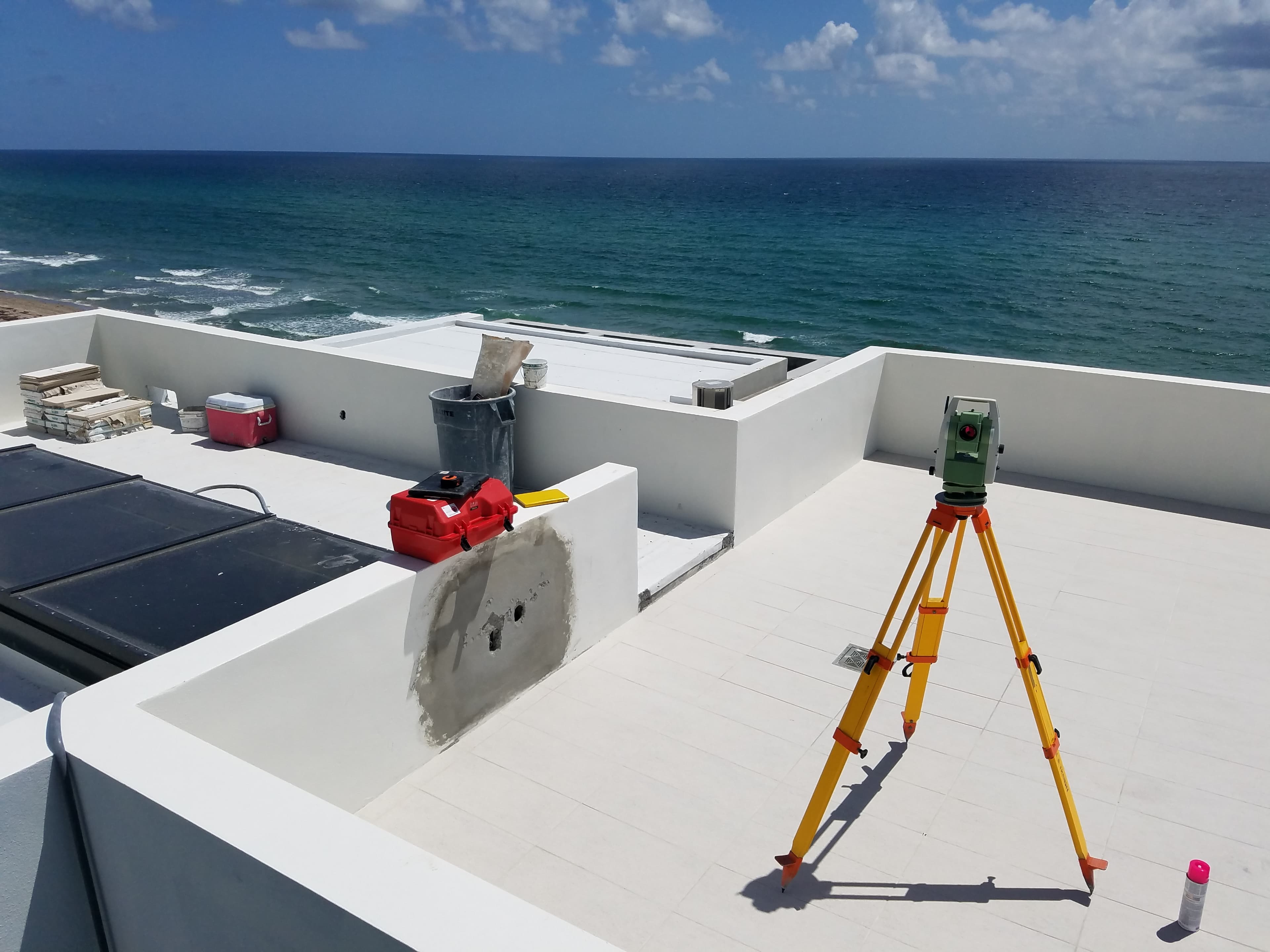JHA survey equipment set up on a rooftop overlooking the Florida coastline